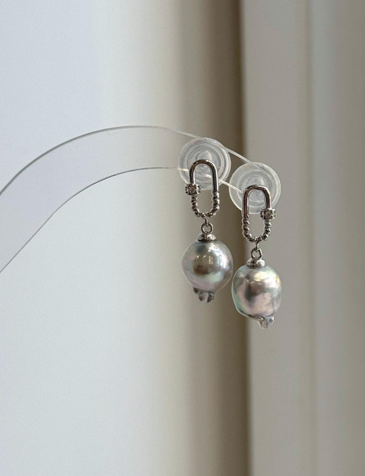 Oval carabiner-style S925 silver settings with suspended Akoya pearl drops.