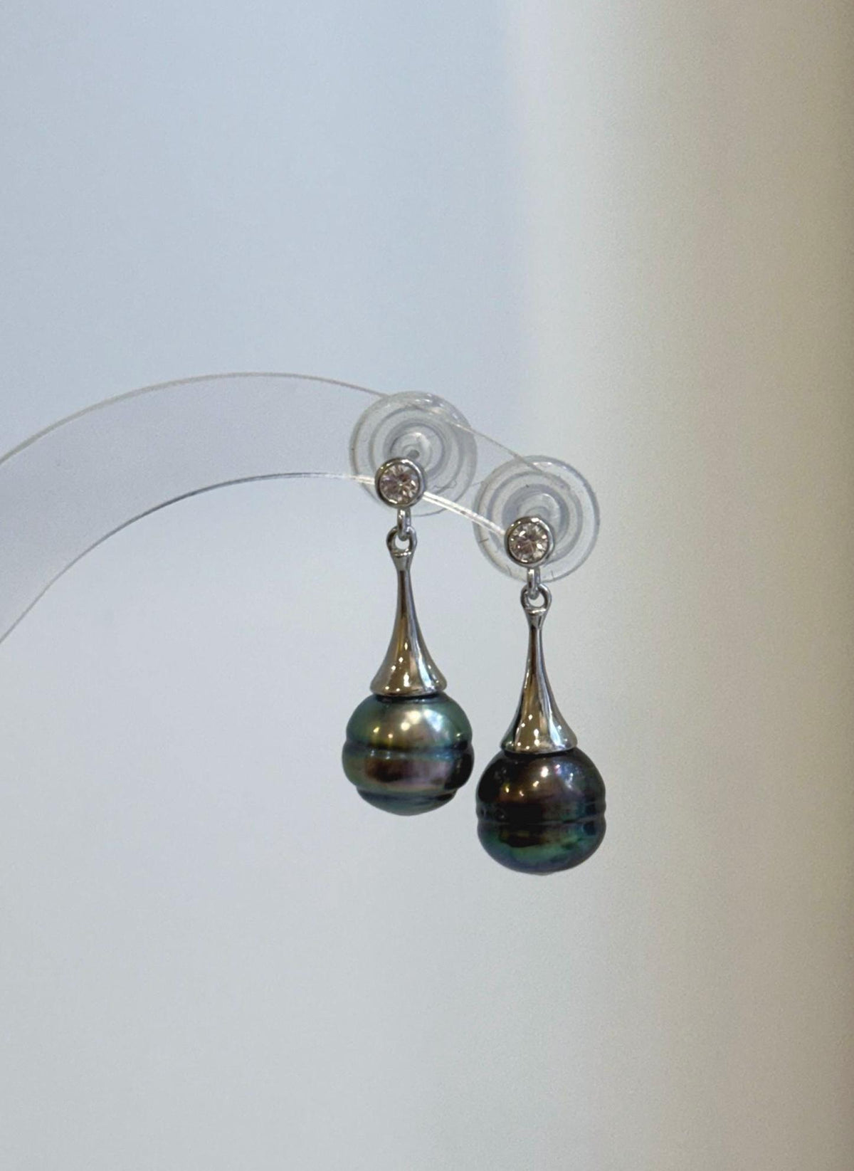 Genuine saltwater Tahitian pearls showing rich green tones in a modern earring design.