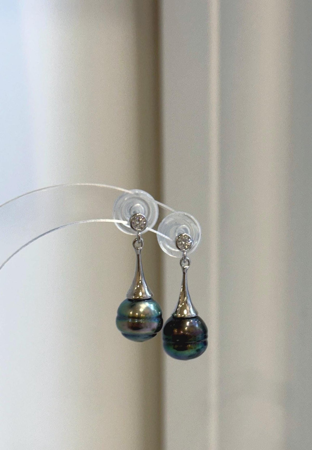 Close-up of the reflective surfaces and peacock green color of the Tahitian pearls.