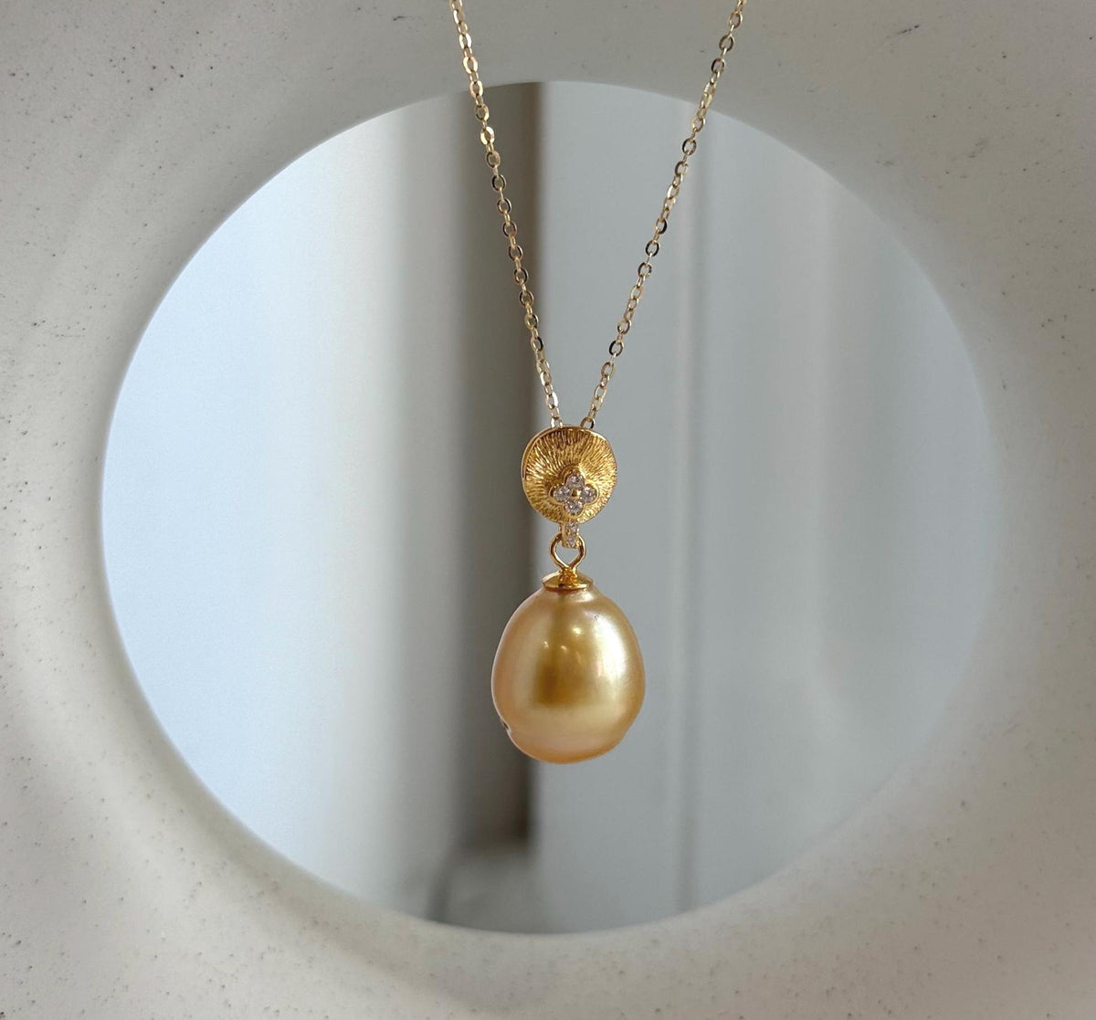 Golden South Sea pearl pendant with a highly reflective surface.