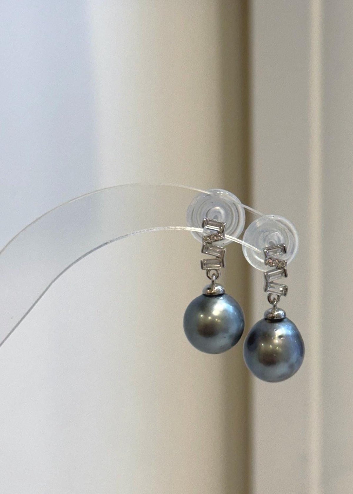 Platinum Tahitian pearl drop earrings with geometric sterling silver settings.