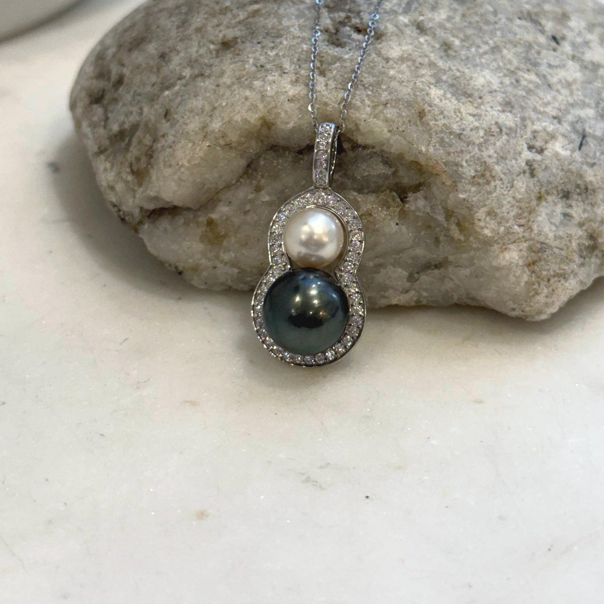 South Sea and Tahitian pearls arranged in a gourd shape with a sterling silver pendant setting.