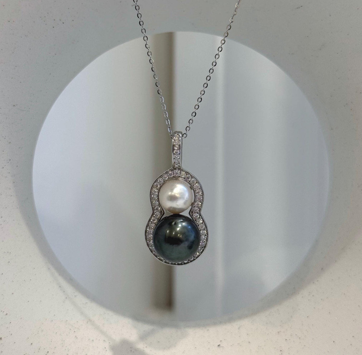 Close-up of the mirror luster on the two genuine saltwater pearls.