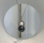 Close-up of the mirror luster on the two genuine saltwater pearls.