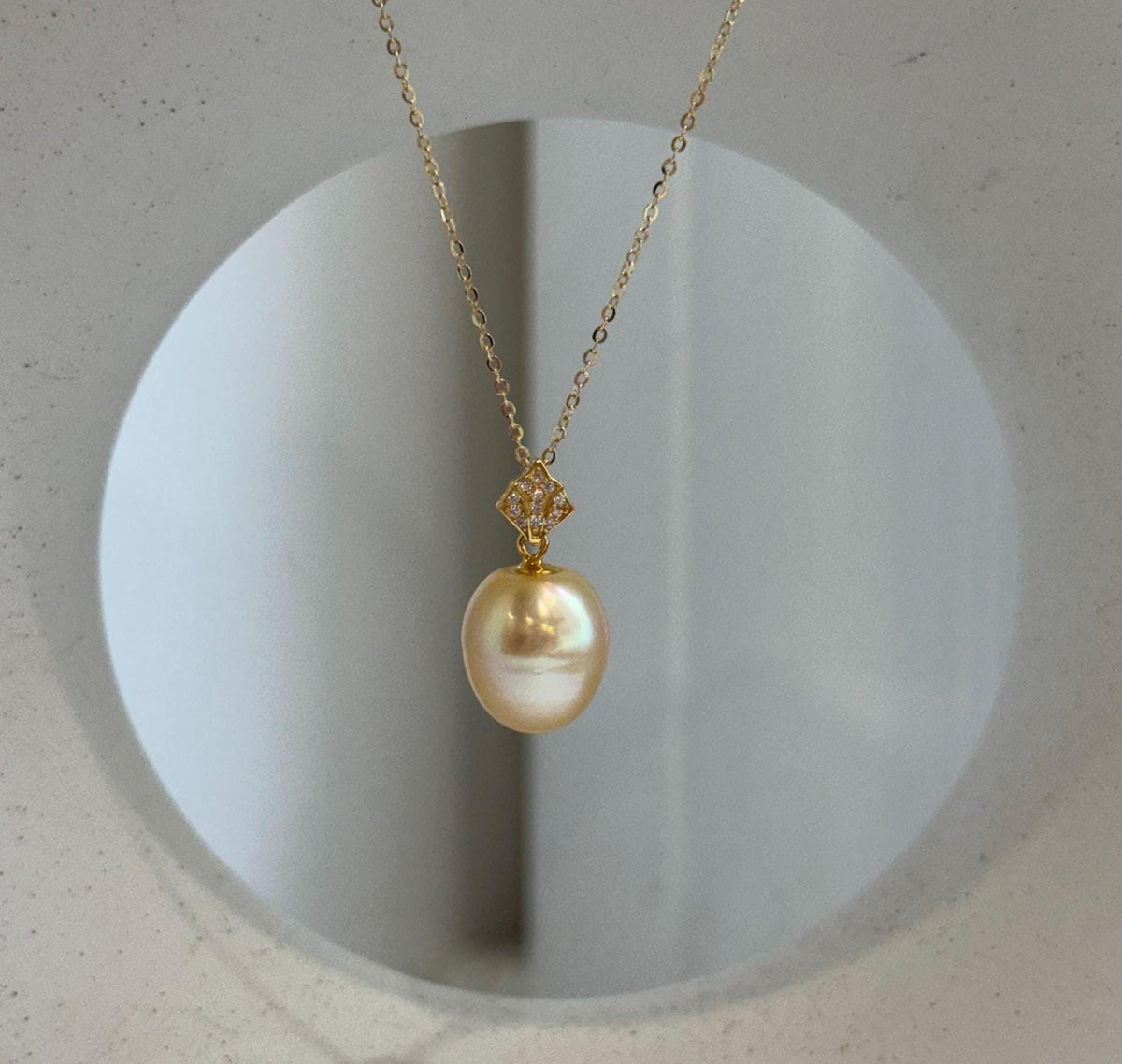 Golden South Sea drop pearl pendant necklace with a crystal-accented S925 sterling silver bail.
