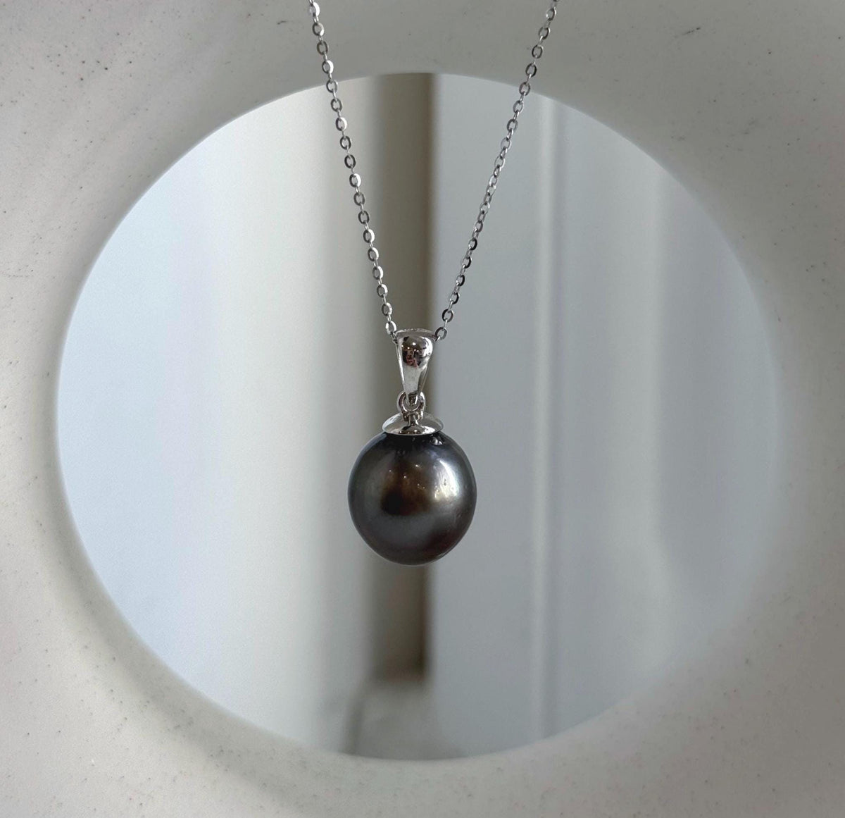 Platinum gray Tahitian pearl pendant with crystal accents and S925 sterling silver setting.