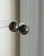 Platinum gray Tahitian pearls set in classic sterling silver stud earrings.