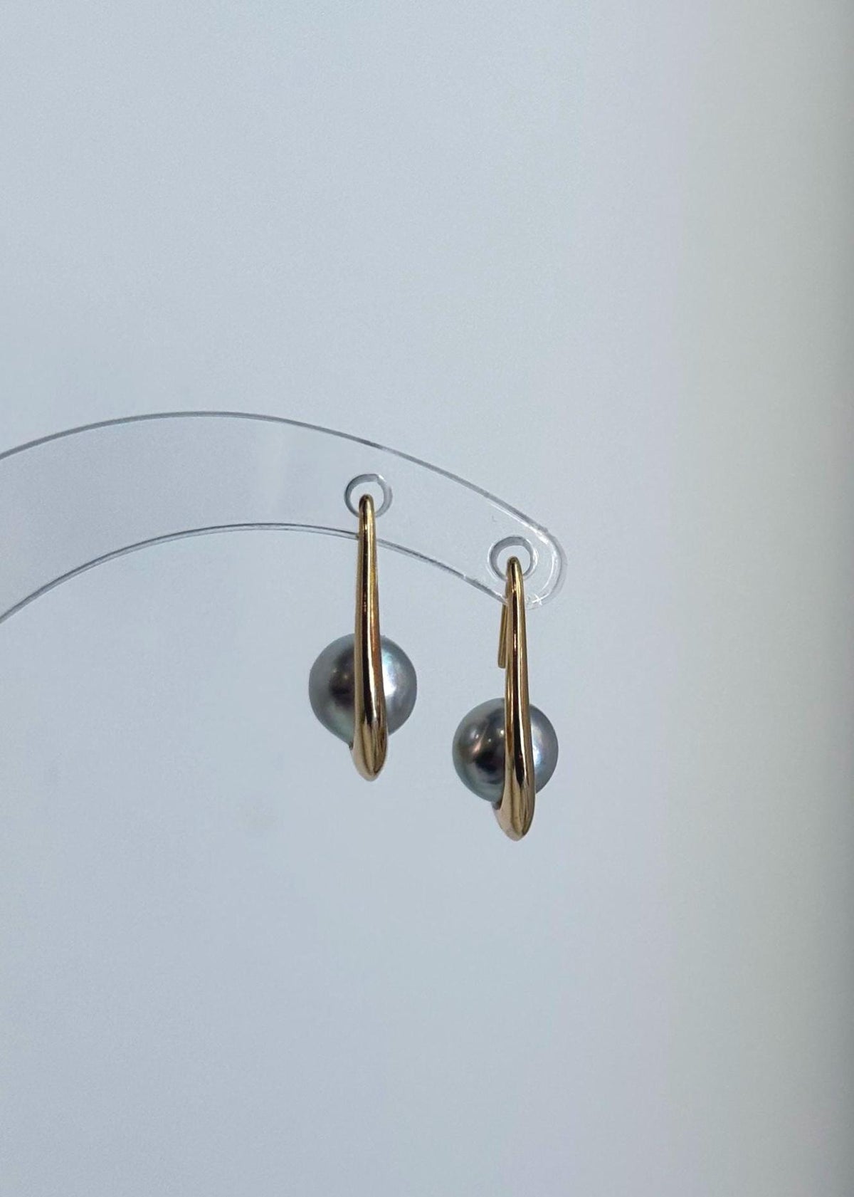 Silver blue pearl drop earrings featuring reflective luster and S925 sterling silver hooks.