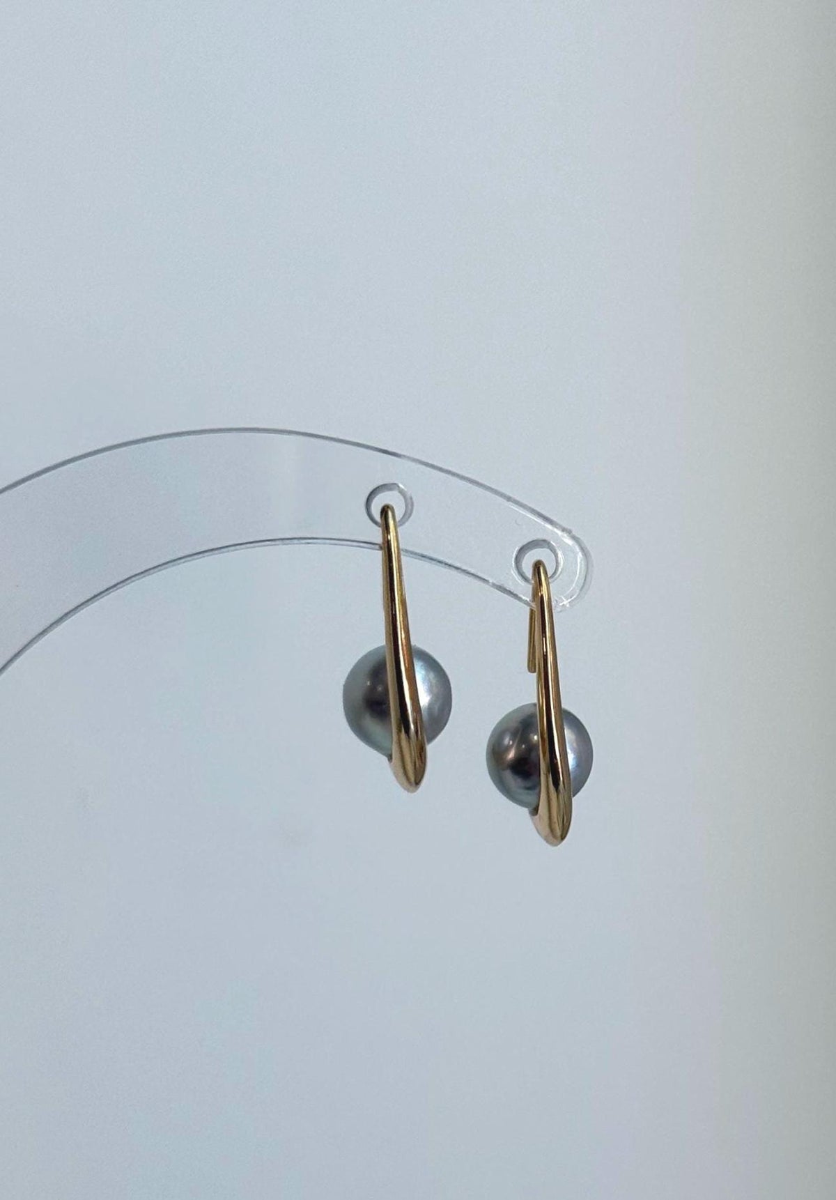 Classic sterling silver hook earrings adorned with lustrous silver blue Akoya pearls.