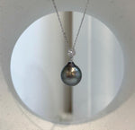 Genuine Tahitian pearl pendant with rich peacock green tones.