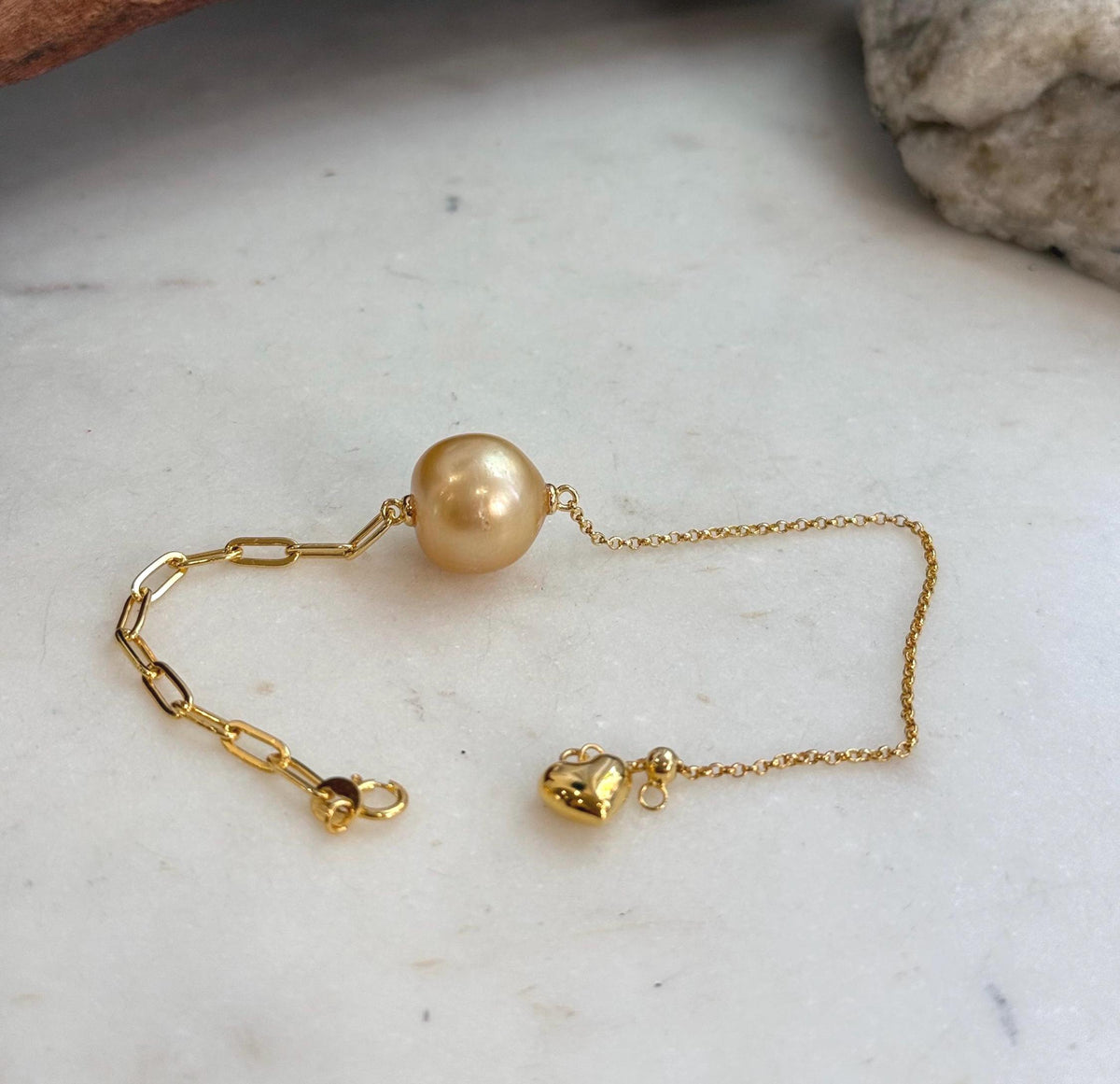 Golden pearl bracelet with paperclip links.