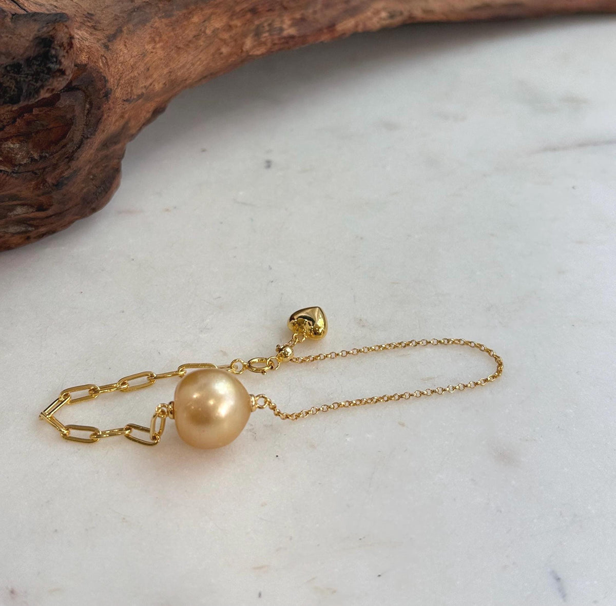 Pearl bracelet with mixed chain styles.