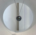 Elly’s piano black Tahitian pearl crystal halo necklace.