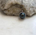 Glossy piano black pearl in a sterling silver pendant.