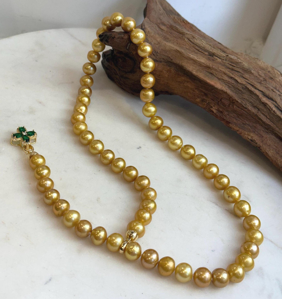 Lustrous golden freshwater pearls strung into a long necklace.