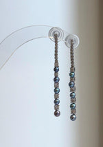 Iridescent freshwater pearls alternating with clear crystal accents.