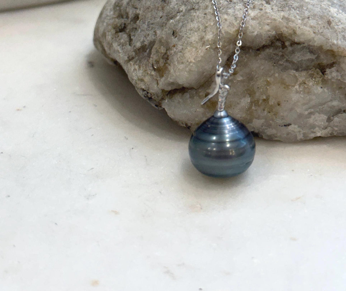 Tahitian pearl necklace with mirror luster and a silver setting.