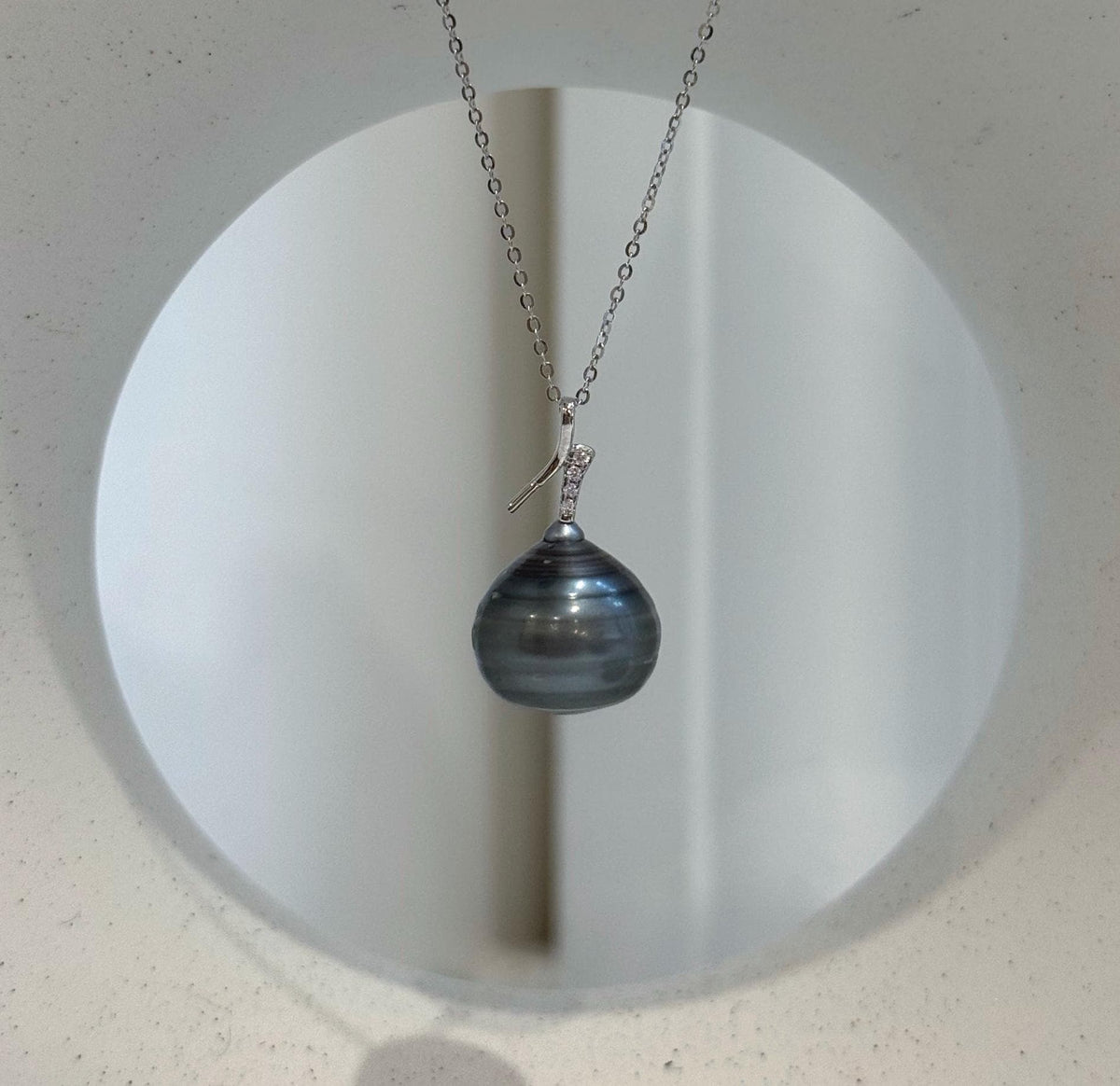 Genuine saltwater pearl pendant with a platinum-colored sheen.