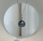 Platinum-colored pearl with a reflective, mirror-like surface.