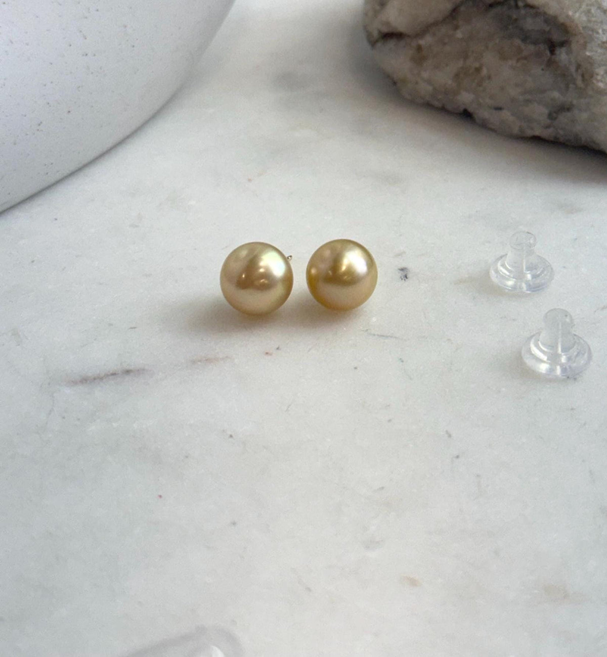 Deep golden pearls in a simple stud earring design.