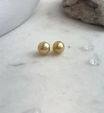 Deep golden pearls in a simple stud earring design.
