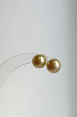 Golden South Sea pearl studs with minimalist silver settings.