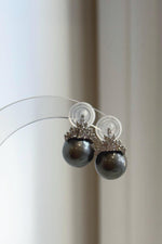 Lustrous gray pearls beneath crystal-accented silver crowns.