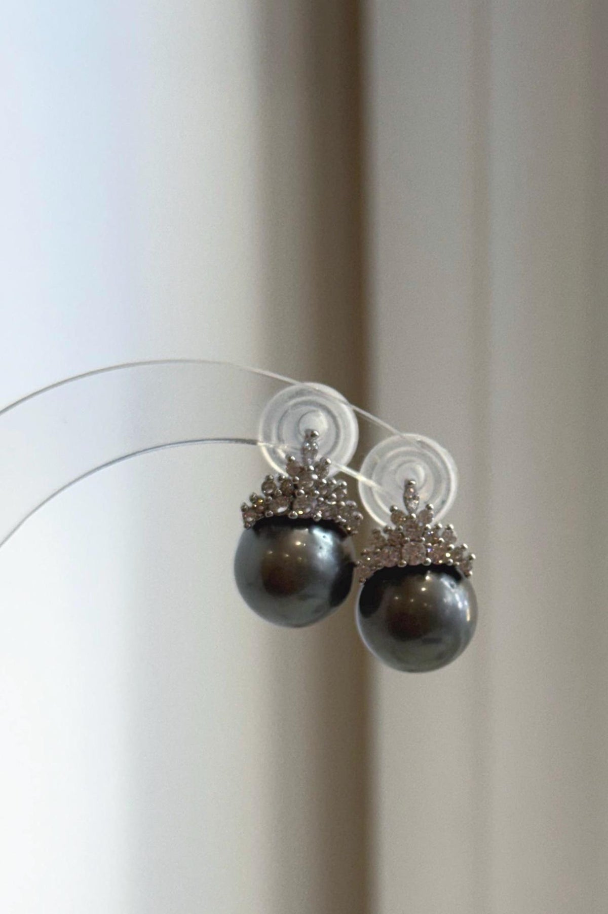 Lustrous gray pearls beneath crystal-accented silver crowns.