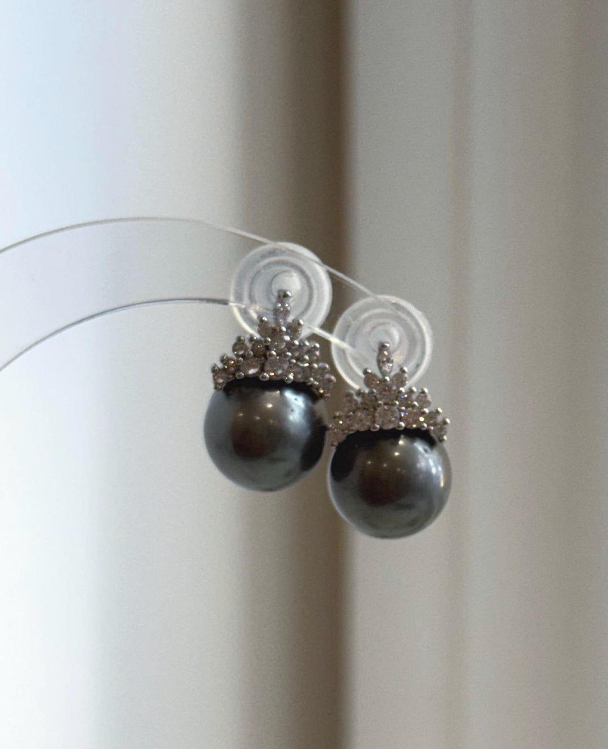 Platinum gray pearl earrings with reflective luster.