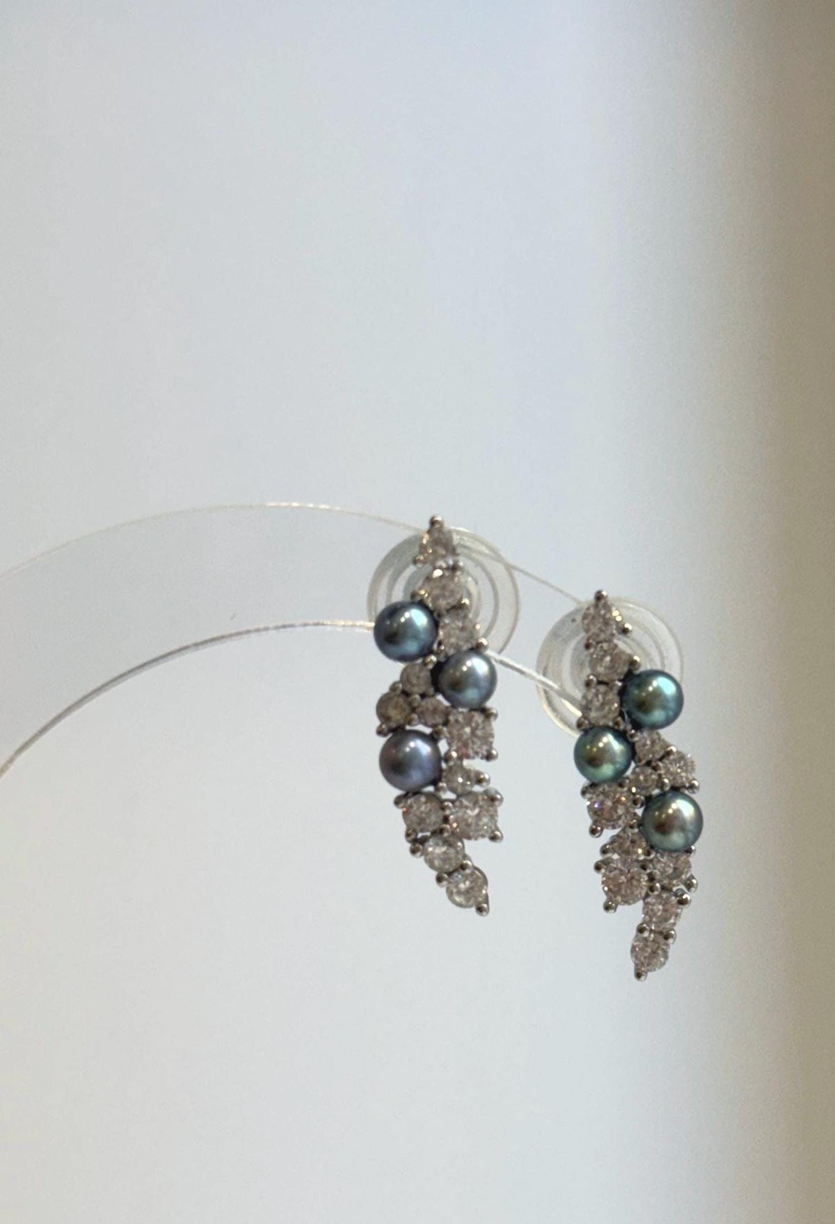 S925 sterling silver earrings with peacock pearls and delicate botanical details.