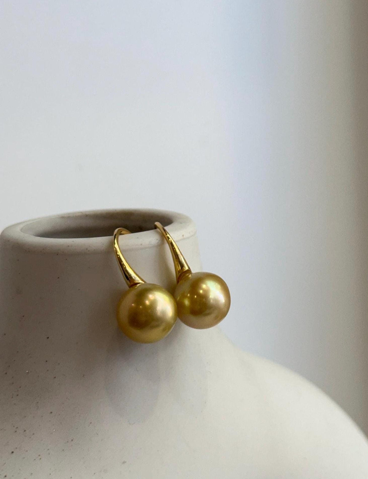 South Sea golden pearl drop earrings with lustrous surfaces.