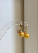 Carved South Sea and freshwater pearl drop earrings on silver hoops.