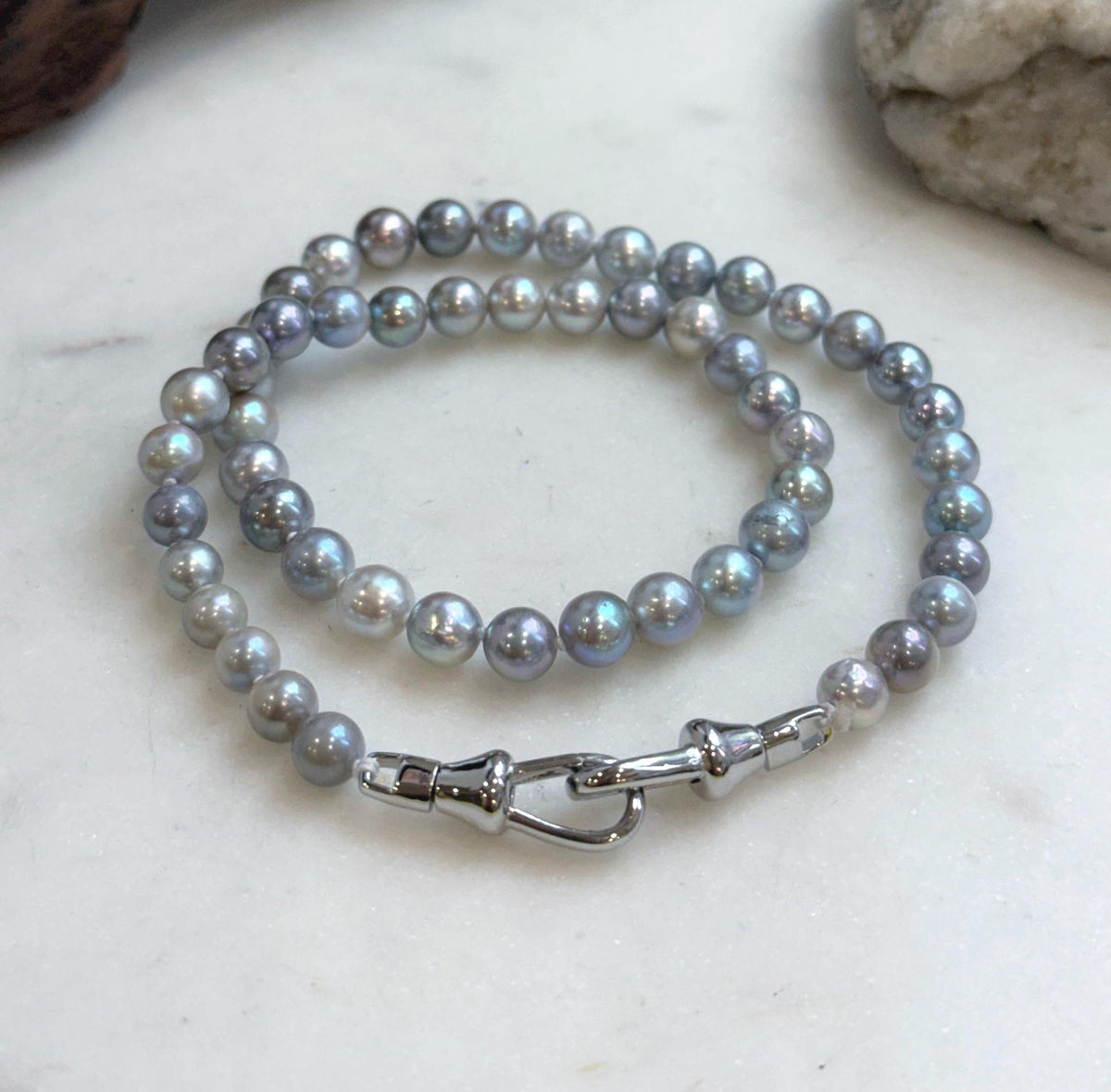 Coiled saltwater pearl necklace with blue, green and soft lavender hues.
