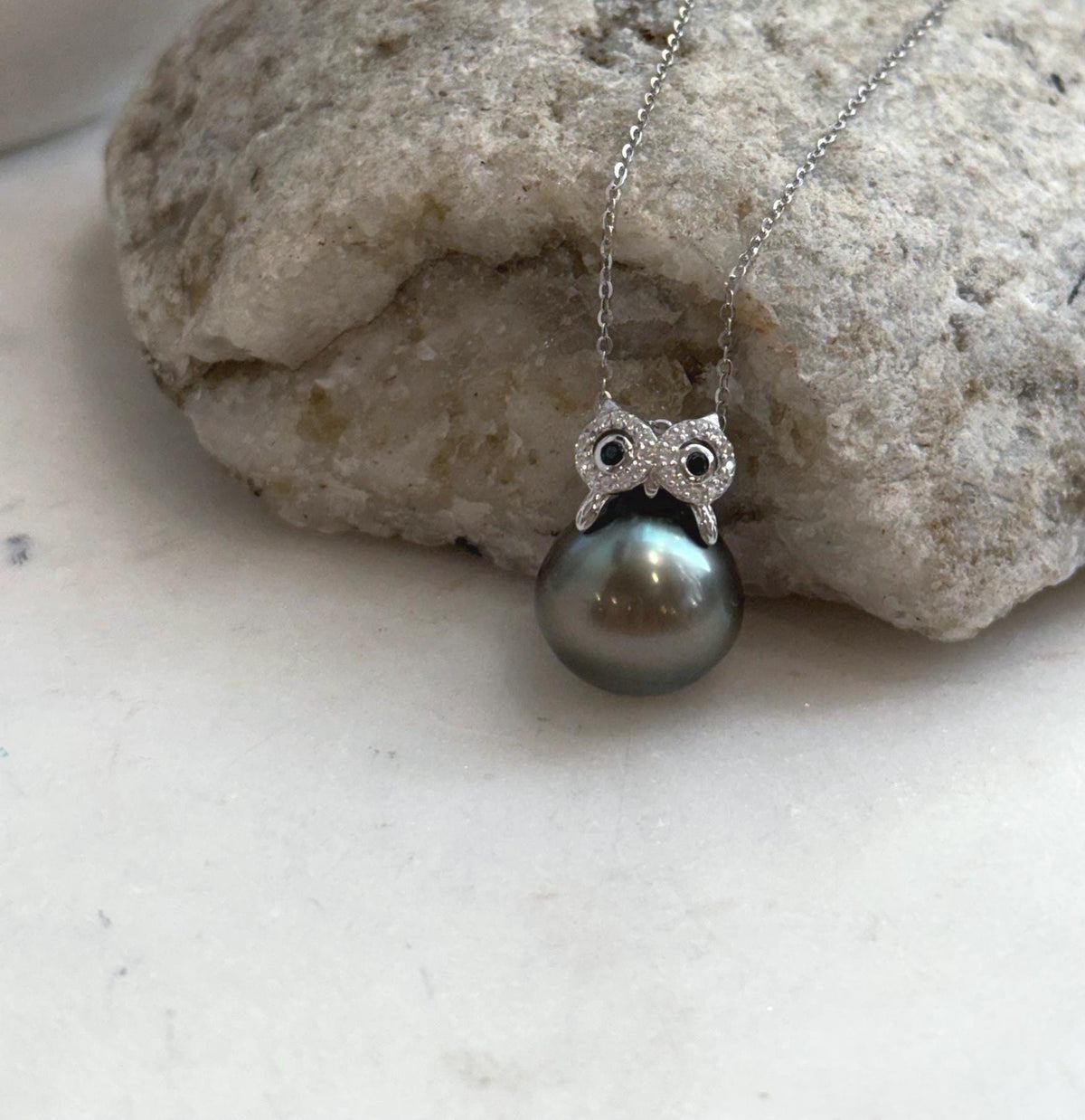 Silver owl pendant featuring a lustrous Tahitian pearl