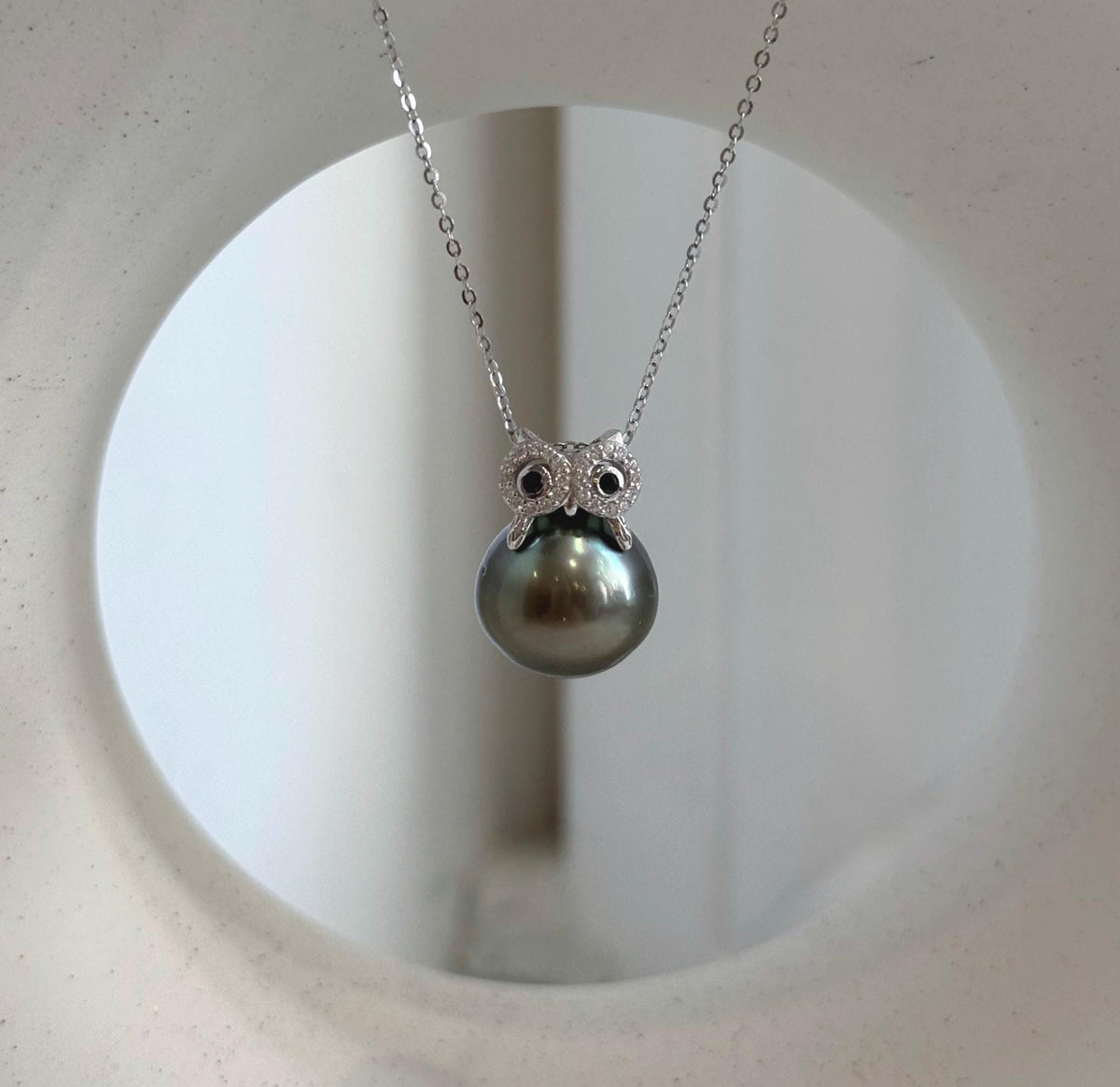 Peacock Tahitian pearl in a crystal-accented owl setting