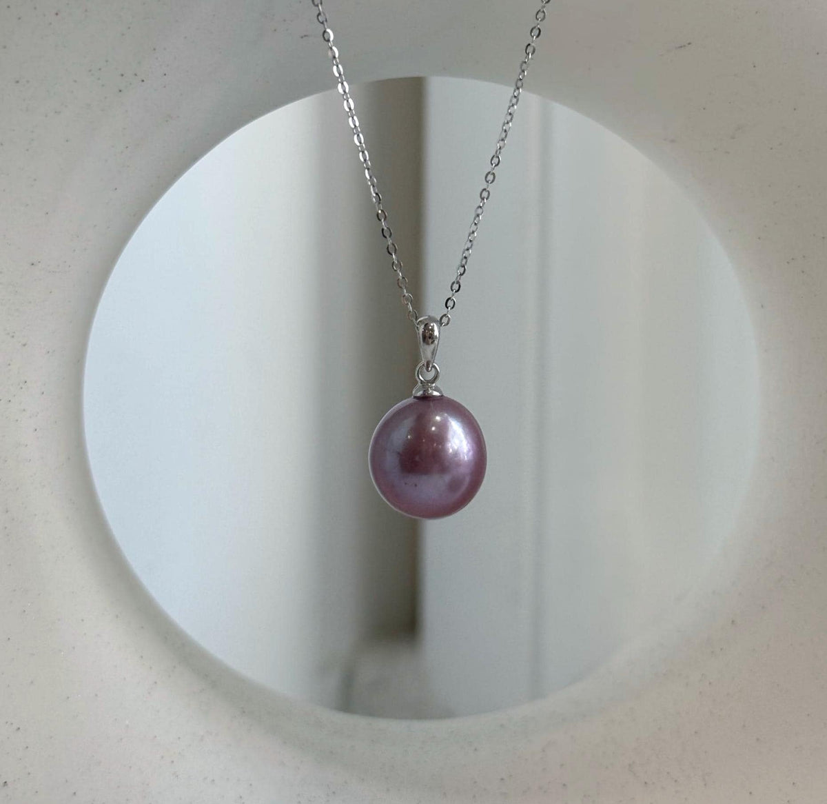 Rose lavender pearl studs shown with sterling silver posts.