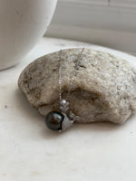 Tahitian pearl necklace with a crystal-accented mermaid design.