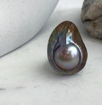 Lustrous saltwater pearl ring with rainbow tones.