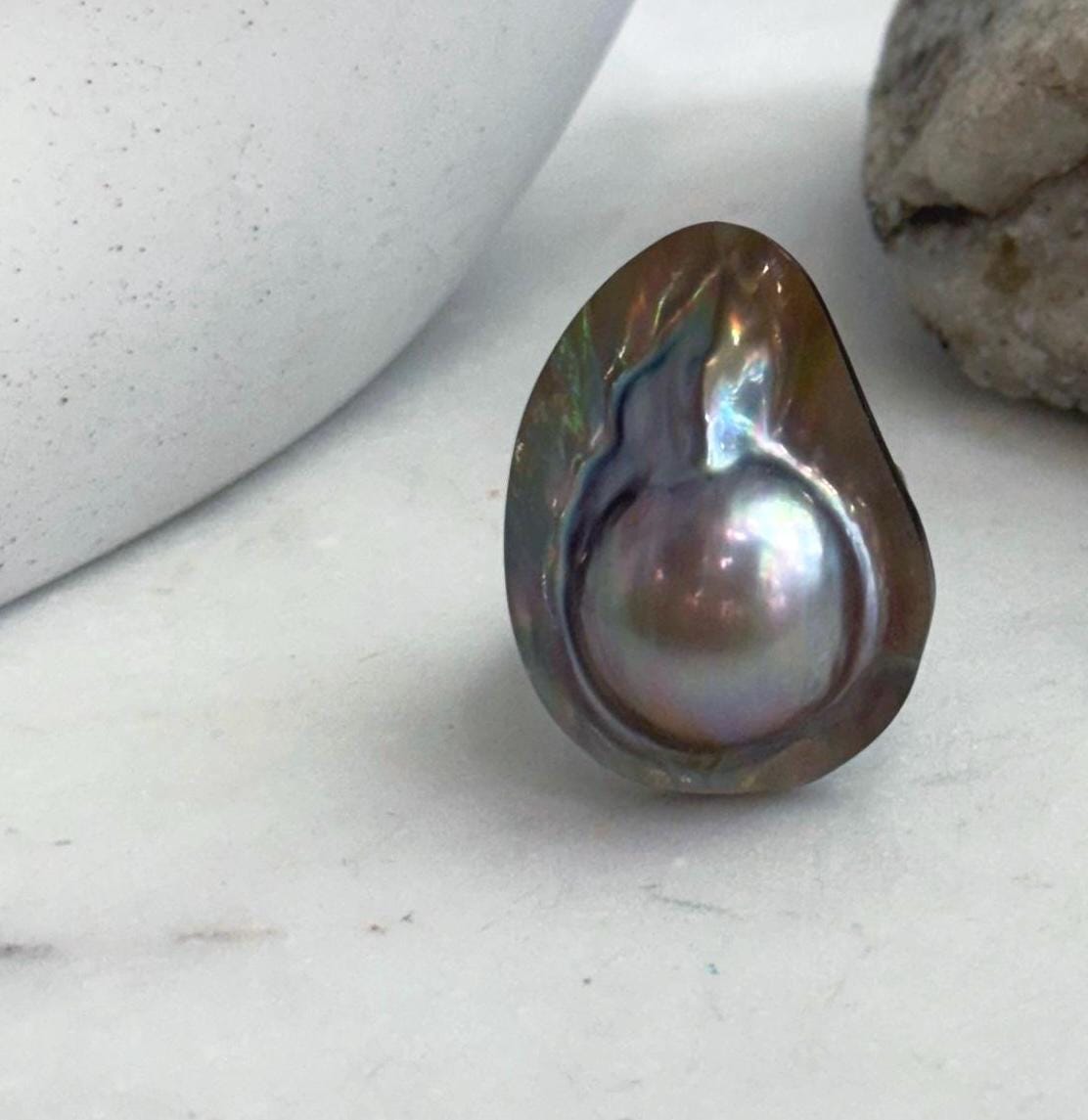 Lustrous saltwater pearl ring with rainbow tones.