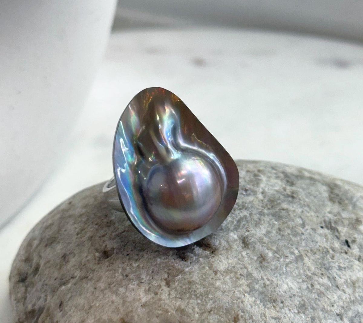 Rainbow iridescence on a genuine saltwater mabe pearl ring.