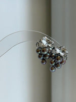 Colorful keshi pearl clusters forming a grape-inspired earring design.