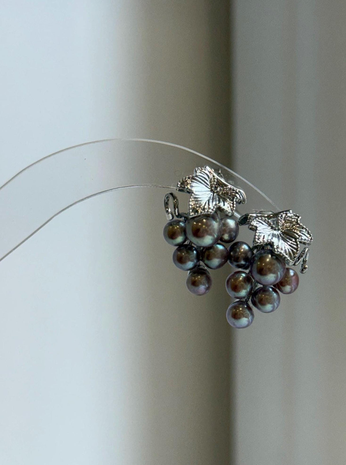 Colorful keshi pearl clusters forming a grape-inspired earring design.