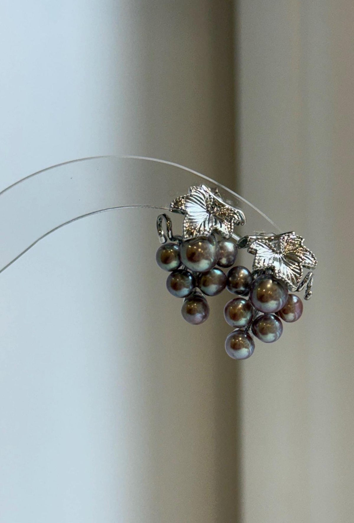 Grape cluster earrings showcasing the iridescent luster of keshi pearls.