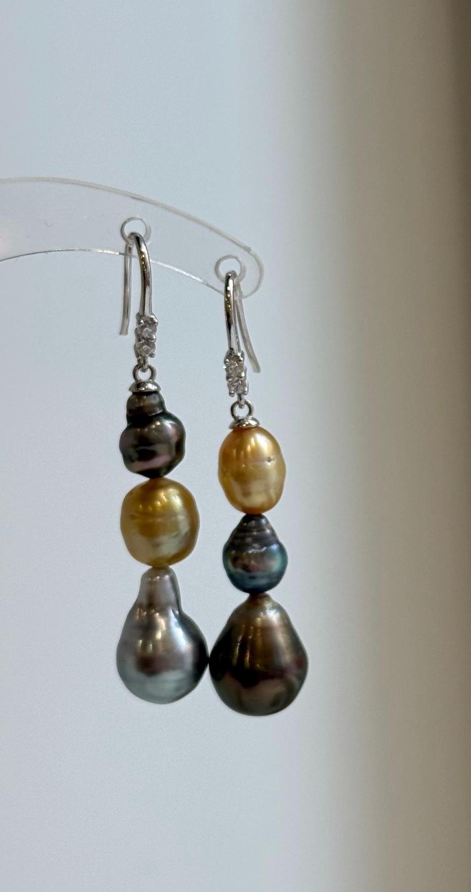 Triple pearl earrings with contrasting gold, blue, and peacock tones.
