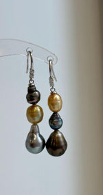 Triple pearl earrings with contrasting gold, blue, and peacock tones.