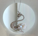 Crystal-accented swan jewelry with a lustrous baroque pearl body.