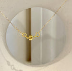Close-up of an iridescent white pearl in a gold-tone swan setting.