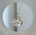 White baroque pearl pendant with blue and pink iridescent reflections.