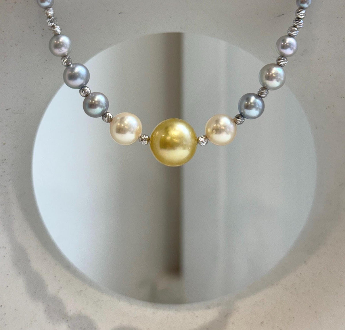 Blue tanzanite beads alternating with pearls and textured silver accents.
