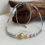 Saltwater pearl necklace with a golden center pearl and blue tanzanite beads.